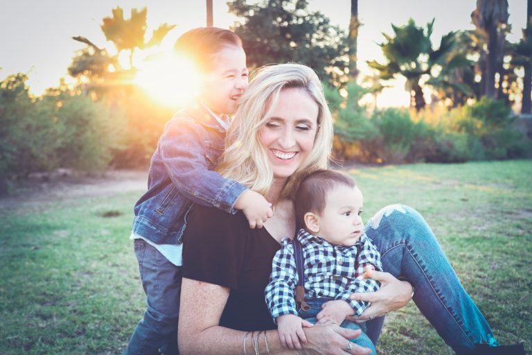 woman playing with her two young children